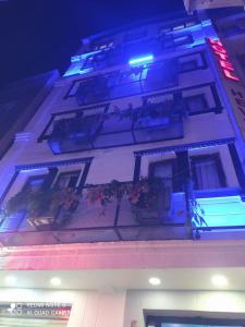 a building with balconies with flowers and lights on it at Hevsel hotel in Diyarbakır
