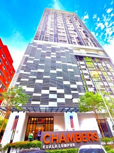a tall building with a sign in front of it at Chamber Suites KL At Sky World in Kuala Lumpur