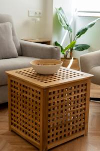 a bowl on a wicker table in a living room at Luxury Gran Vía centro Murcia in Murcia