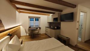 a bedroom with a bed and a desk with a computer at Il Laricino in Predazzo