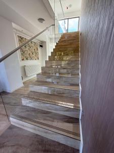 a staircase in a house with wooden floors at Pensiunea Duet in Sărata-Monteoru