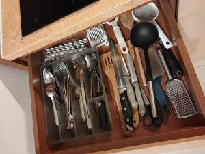 a wooden drawer with utensils in it at Apartmán Lomnica Tatragolf G 108 in Veľká Lomnica