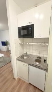 Kuchyň nebo kuchyňský kout v ubytování Modern, quiet apartment right by S-Bahn - close to Munich & airport + 12 fotografií
