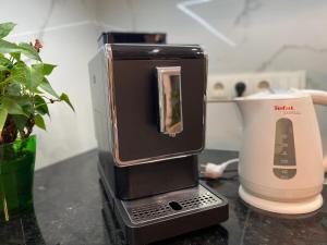 a small appliance sitting on a counter next to a blender at Cappuccino Apartment in new building in Zhytomyr