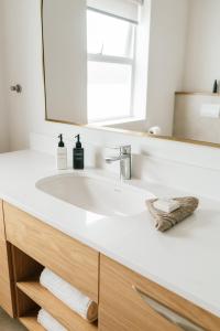 a bathroom with a white sink and a mirror at Patryssenvalleij Farm and Cottages in Stellenbosch +86 photos