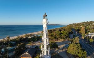 an aerial view of a lighthouse in front of the ocean at McCrae Retreat Brand New Home in McCrae