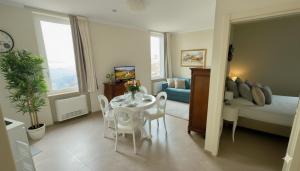 a living room with a table and a bedroom at I Rioni di Perugia in Perugia