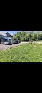 a picture of a house and a yard with a car at Suíomh álainn in Kilgarvan