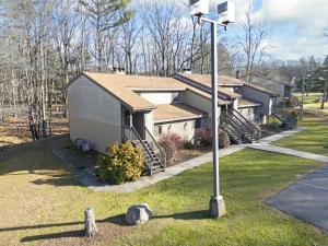 a house with a light pole in the grass at Westwood Villas by Coolvacay in Lake Harmony