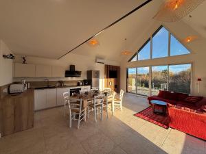 a kitchen and living room with a table and chairs at La Croix Perette in Azay-le-Rideau
