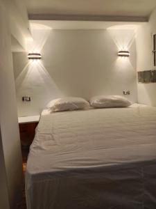 a bedroom with a bed with two pillows on it at Front beach cosy apartment in La Goulette