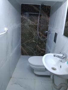 a bathroom with a toilet and a sink at Front beach cosy apartment in La Goulette