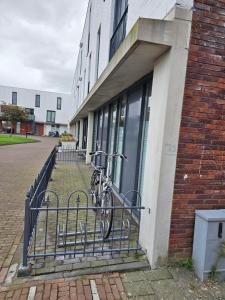 a bike parked on a bike rack next to a building at Kopje van Haaglanden in The Hague +13 photos