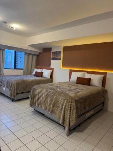 Ένα ή περισσότερα κρεβάτια σε δωμάτιο στο Seu cantinho no Centro do Recife +14 φωτογραφίες