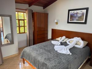 a bedroom with a bed with towels on it at Shumaq Guesthouse in Carhuaz