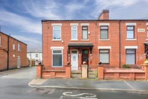 a brick building with a gate in front of it at Modern 4BR Parking in Manchester