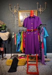 a purple dress and other clothes on a rack at Modern Boho Loft- Observatory in Cape Town