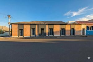 an old brick building on the side of a street at Modern Boho Loft- Observatory in Cape Town