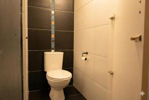 a small bathroom with a toilet in a stall at Modern Boho Loft- Observatory in Cape Town