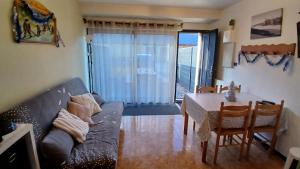 a living room with a couch and a table at Appar T2 3 lits vue montagne terrasse vielle aure in Saint-Lary-Soulan +18 photos