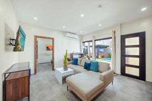 a living room with a couch and a table at Palm Beach Sea La Vie Suites in Palm-Eagle Beach