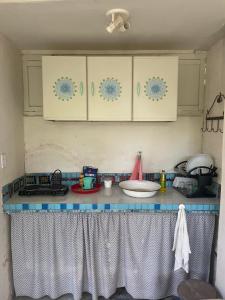 a kitchen counter with a blue and white counter top at Cozy Suite Olinda in Olinda