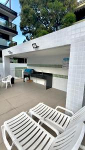 un paio di sedie bianche sedute su un patio di Refúgio à Beira-Mar Cabo Branco João Pessoa a João Pessoa