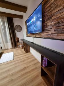 a living room with a flat screen tv on a wall at Esprit Chalet en centre ville Confort et charme in Tours