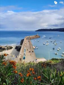 a dock with boats in a body of water at Apt de charme, les pieds dans l'eau in Plérin +25 photos