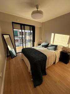 a bedroom with a large bed and a large window at En el Corazón de Rosario in Rosario