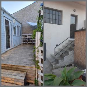 a home with a wooden deck next to a building at U Herolda in Rakvice