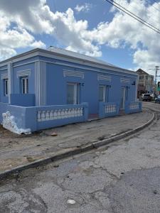 a blue building on the side of a street at Mereri downtown apartments, apartment 13C in Oranjestad +12 photos