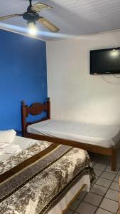 Postel nebo postele na pokoji v ubytování Pousada Simples Aconchego