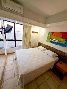 una camera da letto con un letto grande e una grande finestra di tropical Flat Belissimo a Manaus