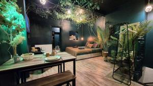 a bedroom with a bed and a table in a room at Amazonia - Private Spa and Cinema in Boulogne-sur-Mer