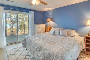 a blue bedroom with a bed and a window at Private Lakefront Home with Views and Dock in Hartwell in Reed Creek