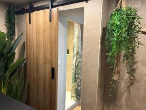 a room with a door with plants on the wall at Thermo'Spa - Gîte Spa Privatif in Calais +38 photos