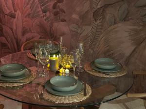 a table with plates and glasses on top of it at Thermo'Spa - Gîte Spa Privatif in Calais