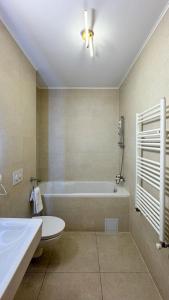 a bathroom with a tub and a toilet and a sink at VENUS Studios at Coresi Mall in Braşov +19 photos