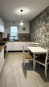 a kitchen with a table and a table and chairs at VENUS Studios at Coresi Mall in Braşov
