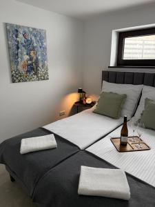 a bedroom with two beds and a bottle of wine at Apartament u Bacy in Nowy Targ