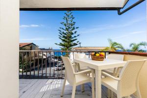 a white table and chairs on a balcony with a tree at Tropea Solemare in Tropea