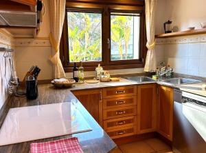 a kitchen with a sink and a window at Beachhouse 2min to the sea with pool & wonderful garden in Calvia Town