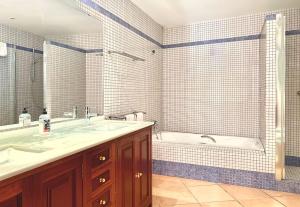 a bathroom with a tub and a sink and a bath tub at Beachhouse 2min to the sea with pool & wonderful garden in Calvia Town +14 photos