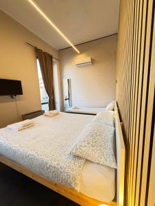 a bedroom with a large bed with at The Central Rock Inn camere con bagno privato self check in in Piacenza