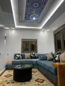 a living room with a couch and a blue ceiling at Dar Ouadie Serene Blue in Chefchaouen