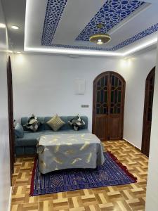 a living room with a couch and a blue ceiling at Dar Ouadie Serene Blue in Chefchaouen +13 photos
