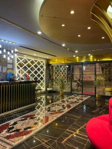 a lobby of a store with a red chair at Golden Lux Hotel Antalya in Antalya