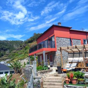 a red house on a hill with a view at casa2sonhos in Água de Pena