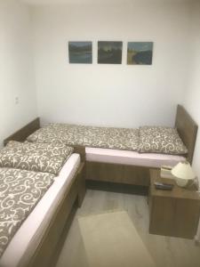 a bed in a room with a table and two pictures at Villa Mila in Ludbreg